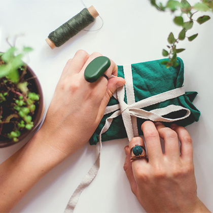 Bow being tied around a small gift